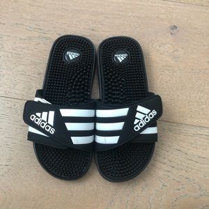 Black and white adidas slides